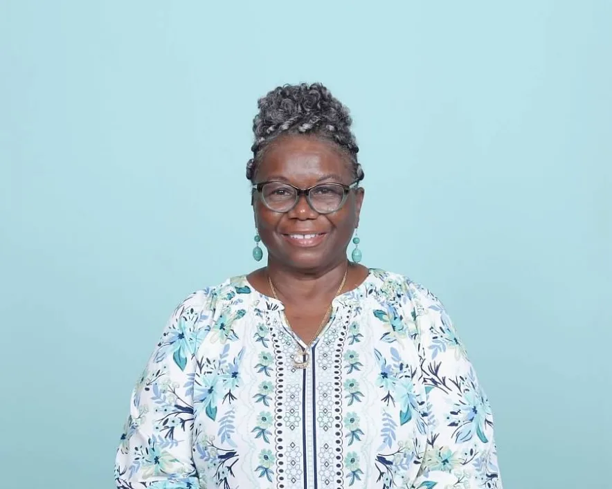 Mary Kirkland smiles in a professional portrait wearing a blue floral blouse.