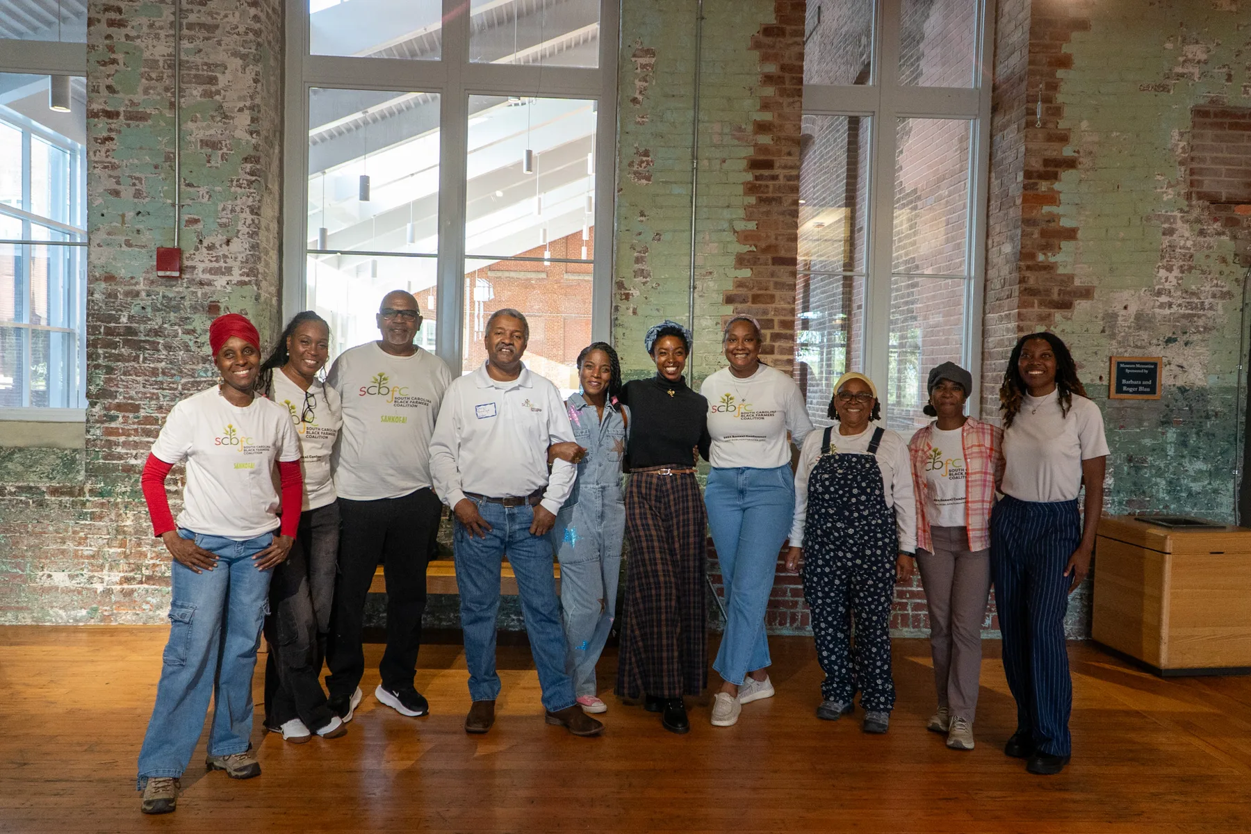 A large group poses together at a community gathering.