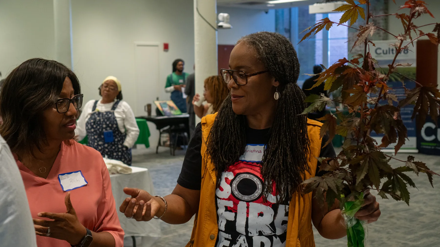 Two people talk animatedly during a community gathering.