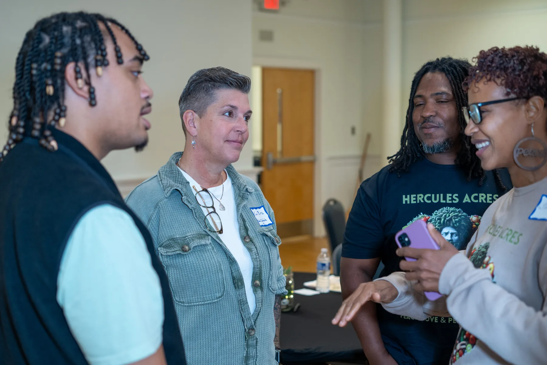 Several people talk together during a break at a gathering.