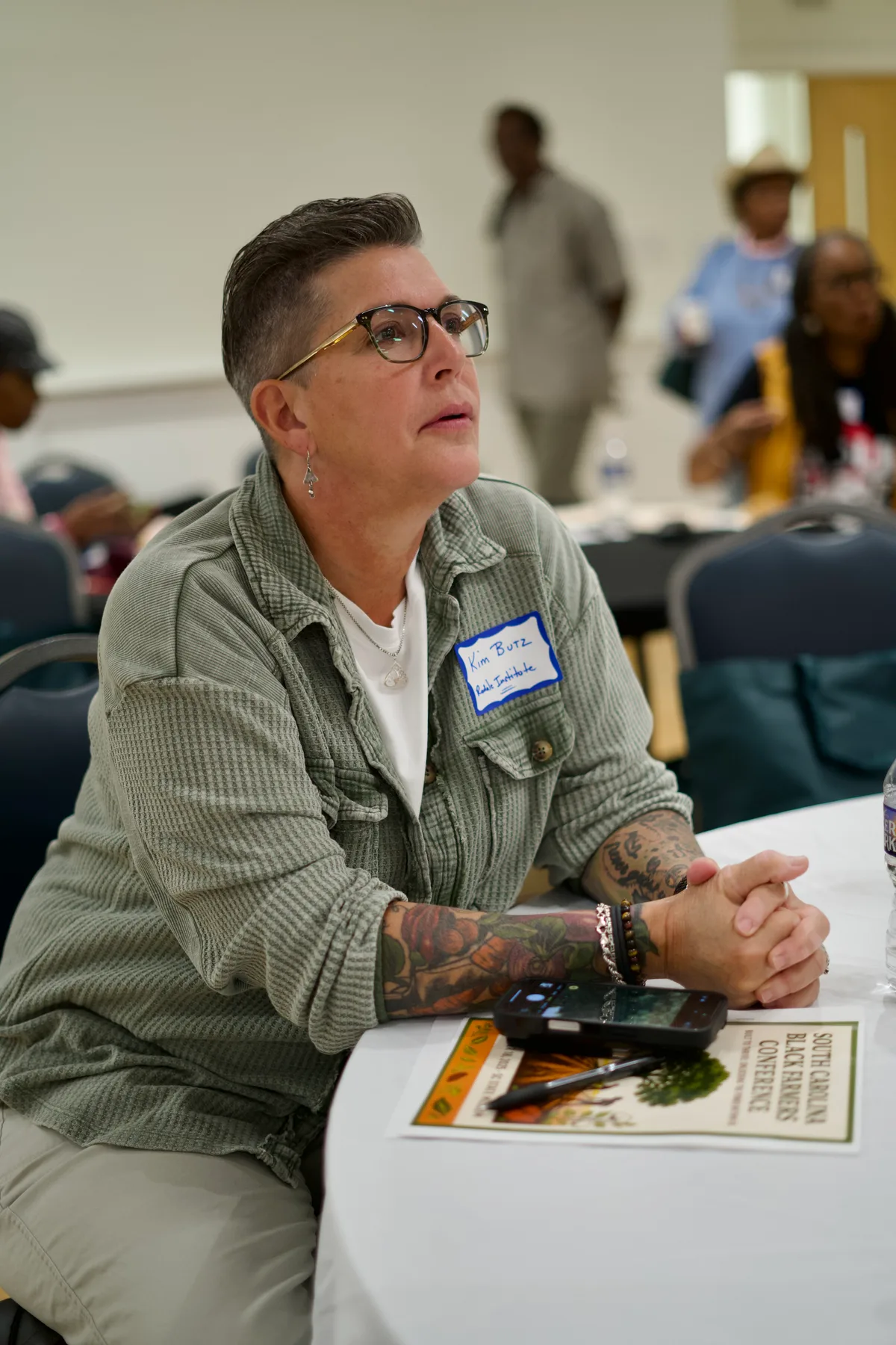 A person sits at a table with printed materials during a session.