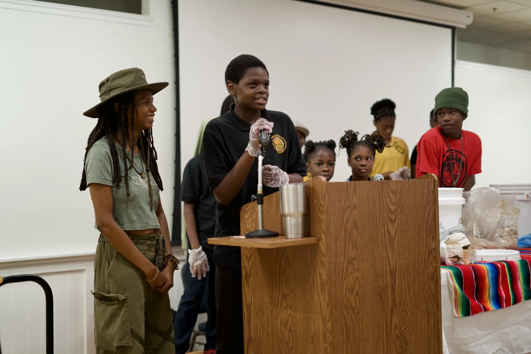 A young person speaks during a group presentation.